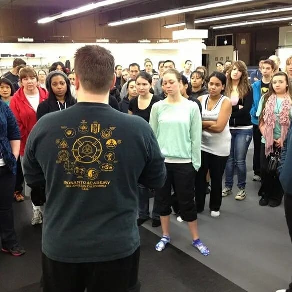 group of students listening to instructors for self defense lessons